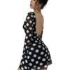 Model wearing LuckeLadybug backless mesh flare sleeve dress black polka dot mini with sheer long sleeves