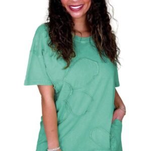 Woman wearing a mint green t shirt dress with floral stitch details and short sleeves