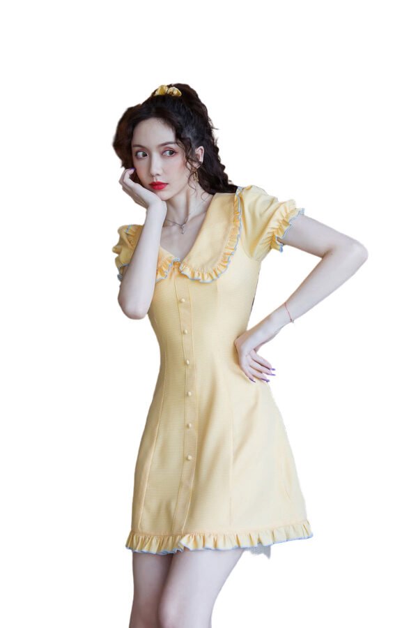 Model wearing yellow bellflower a-line dress with ruffle collar and button front in marble bathroom setting