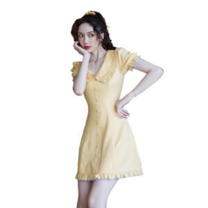 Model wearing LuckeLadybug bellflower a-line dress in soft yellow with ruffled collar puff sleeves