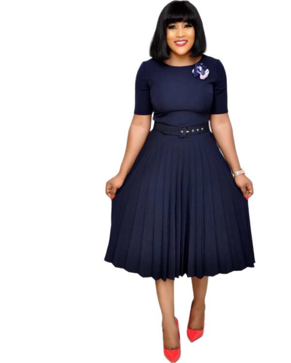 Plus size pleated dress for women in navy blue with belt and floral brooch styled by LuckeLadybug