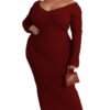 Plus size V-neck dress in dark red with long sleeves worn by a woman accessorized with earrings and a small handbag