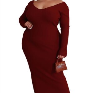 Plus size V-neck dress in dark red with long sleeves worn by a woman accessorized with earrings and a small handbag