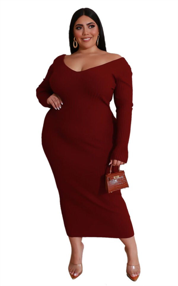Plus size V-neck dress in dark red with long sleeves worn by a woman accessorized with earrings and a small handbag