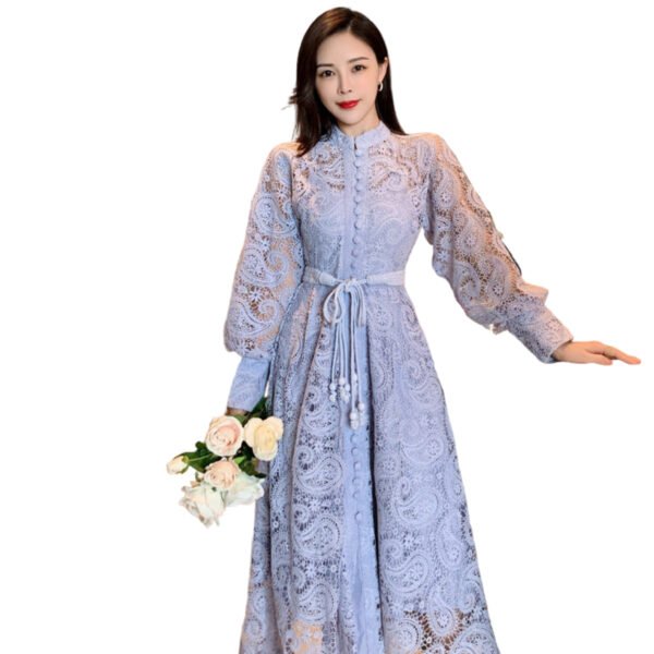 Woman wearing purple lace princess dress with long balloon sleeves and sash holding white rose bouquet in elegant interior