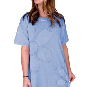 Woman wearing a sky blue t shirt dress with large floral embroidery by LuckeLadybug LLC