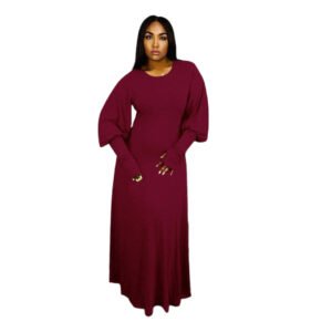 Elegant burgundy plus size evening dress with long puff sleeves worn by model indoors