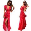 Red polka dot v neck maxi dress with short sleeves and side slit worn with sunglasses and red purse