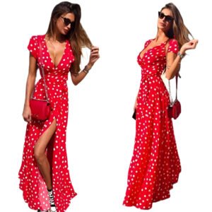 Red polka dot v neck maxi dress with short sleeves and side slit worn with sunglasses and red purse